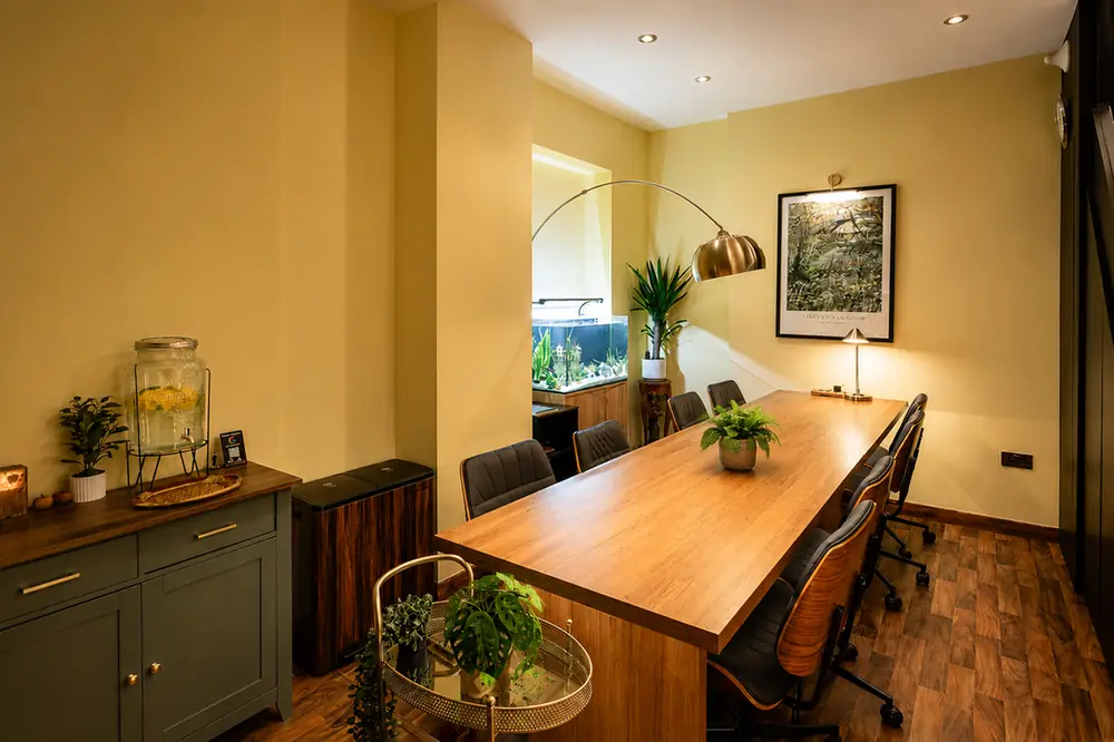 The long wooden table under the arc lamp at BC Atelier, set for a focused session